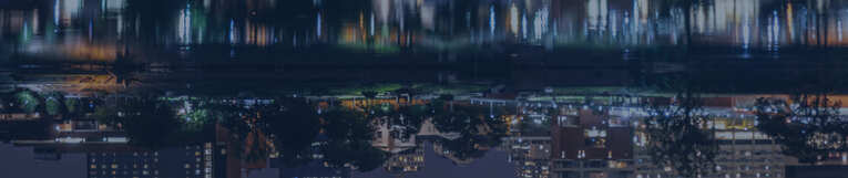 town image mirroring on river at night