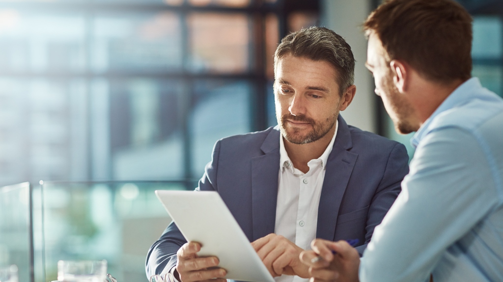 businessman reviews documents with lawyer