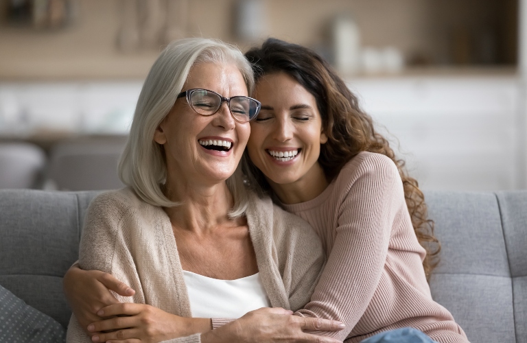 Happy excited senior mom and adult daughter woman having fun at home