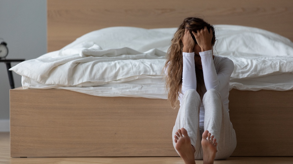 In the morning desperate woman sit on floor