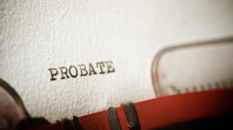 Close-up of typewriter typing the word "PROBATE" on textured white paper.